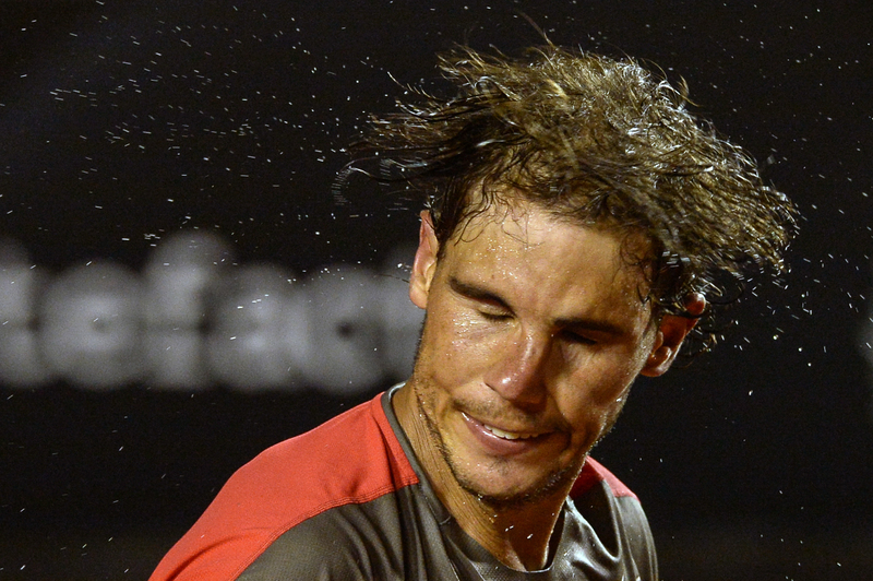 Watering the Grass | Getty Images Photo by YASUYOSHI CHIBA/AFP